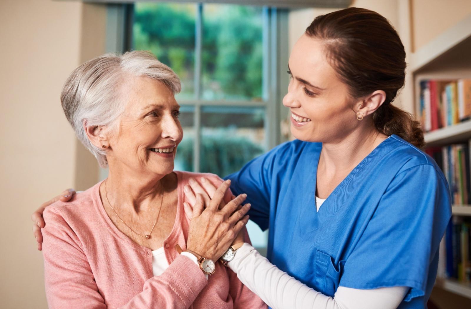a carer and a senior embrace in support